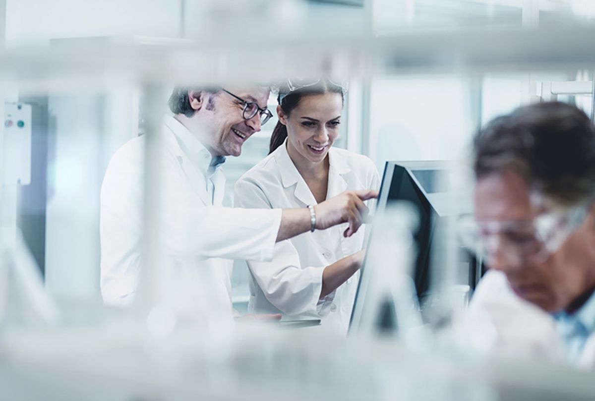 People in lab working on a screen together